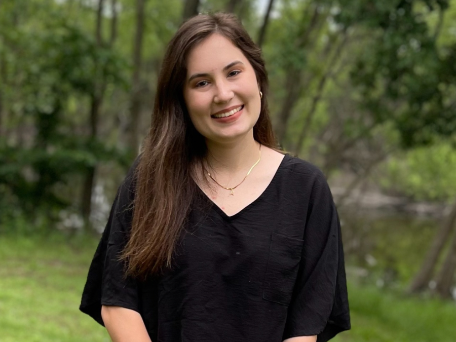 Photo of Anna Farve, black shirt, against green grass backdrop