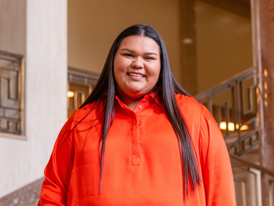 Chenoa Turtle in orange shirt against OSU backdrop
