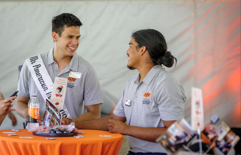 Mister American Indian OSU Luke pictured laughing and talking with his friend and NASA executive member Josiah at the Center for Sovereign Nations birthday event.