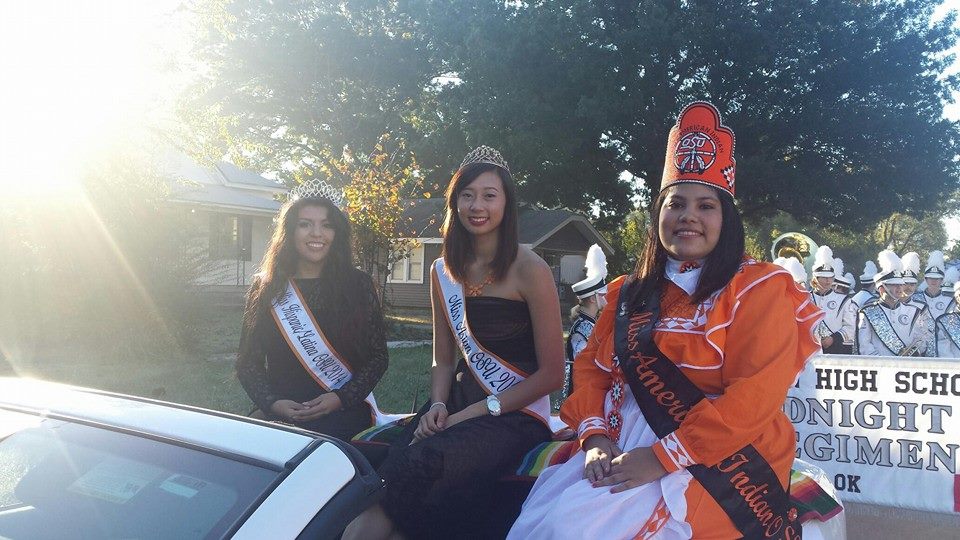 Miss American Indian OSU Veronica pictured with Miss Asian OSU and Miss Hispanic OSU at the Homecoming Parade, sitting in the royalty car.