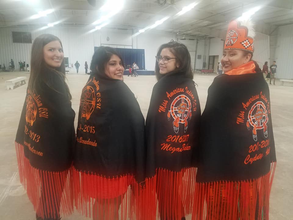 4 Miss American Indian OSU Pictured standing together showing thier MAIOSU shawls at Annual Powwow