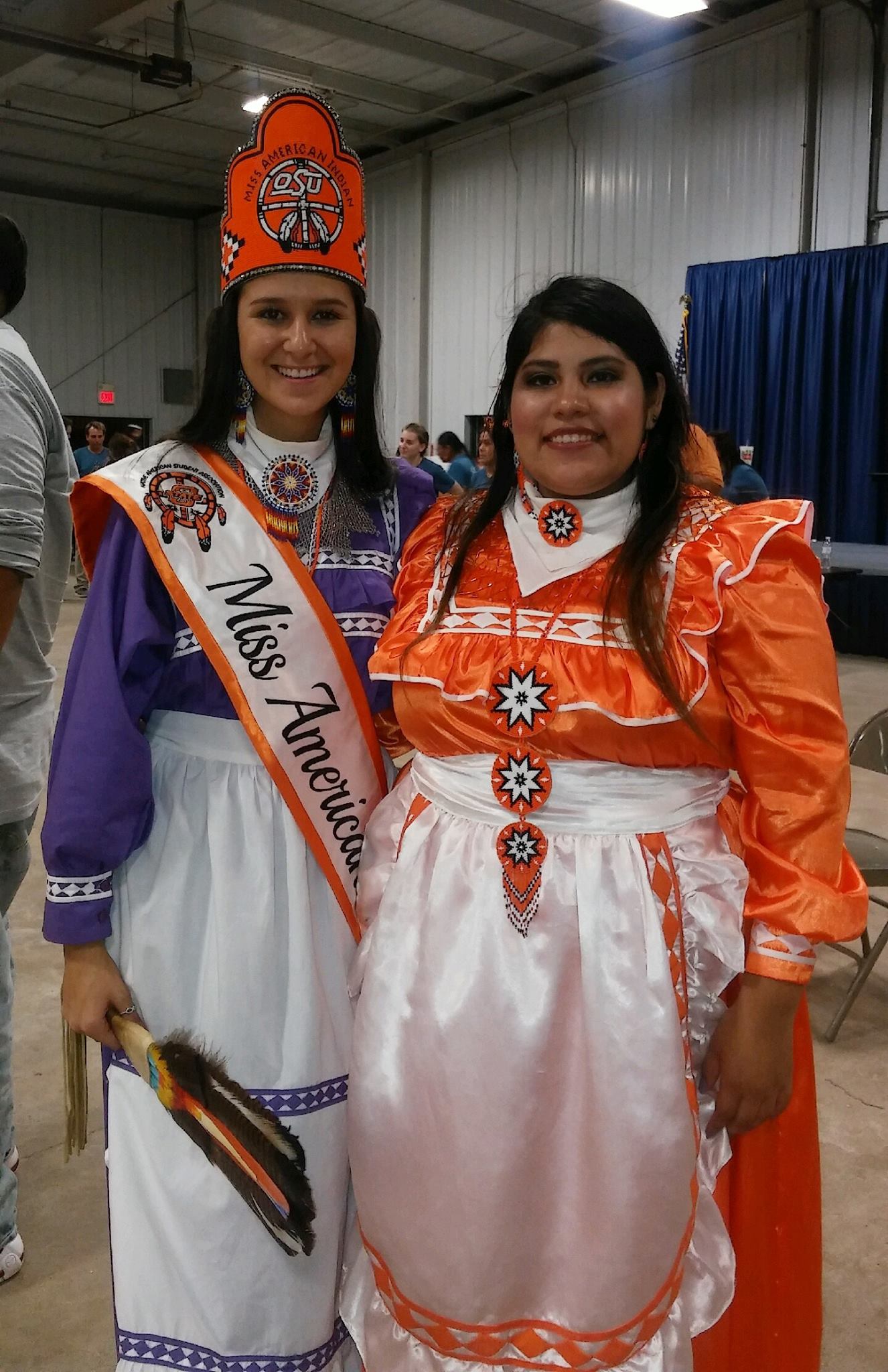 Miss American Indian OSU Cathrine posing with former MAIOSU titleholder Veronica.