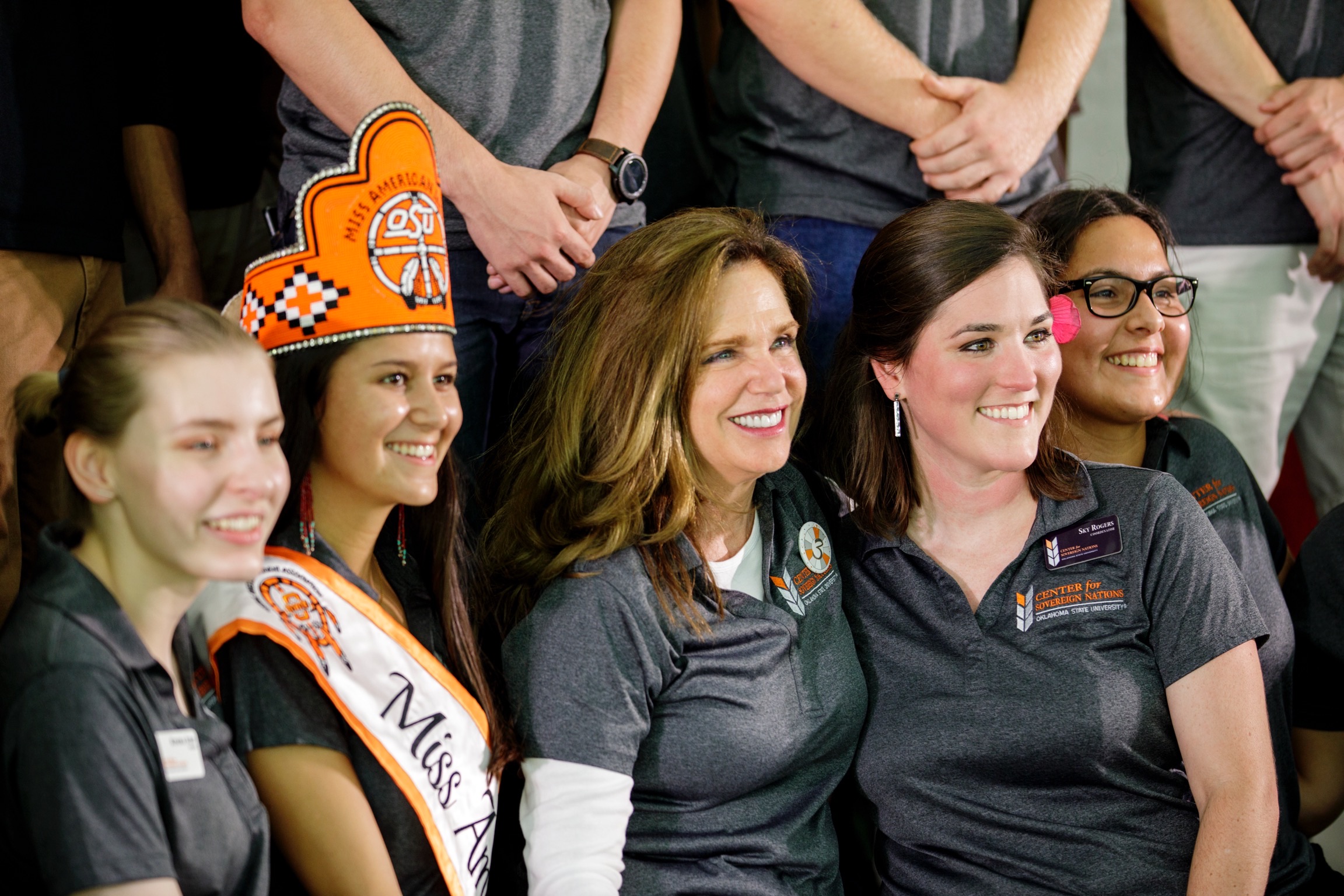 Miss American Indian OSU Cathrine smiling, pictured with Elizabeth Payne, founding director, and Sky Rogers, interim director, at the Center for Sovereign Nations birthday event.