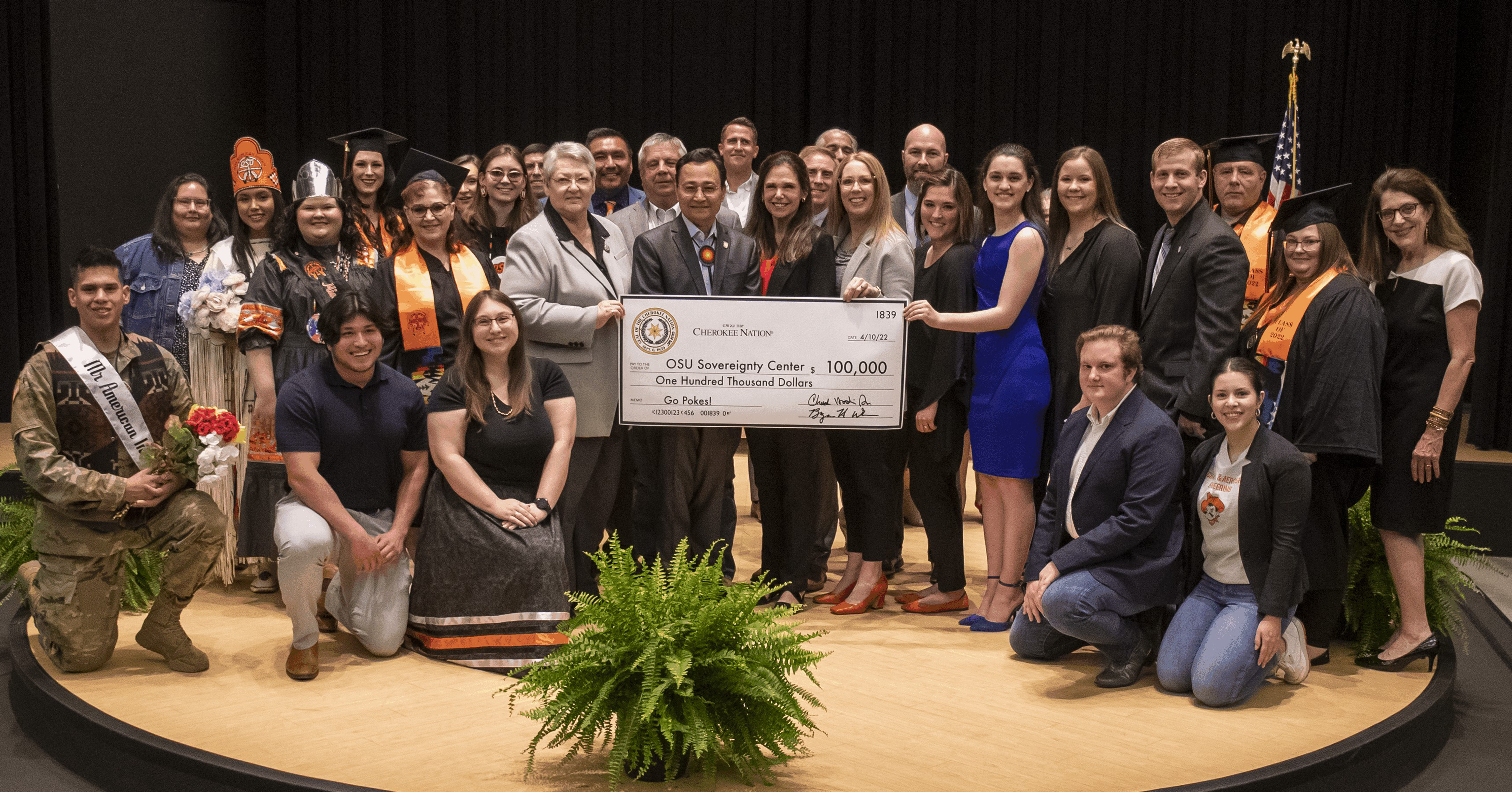 A group of NASA and CSN students taking a group photo with a 100,000 dollar check in their hands.